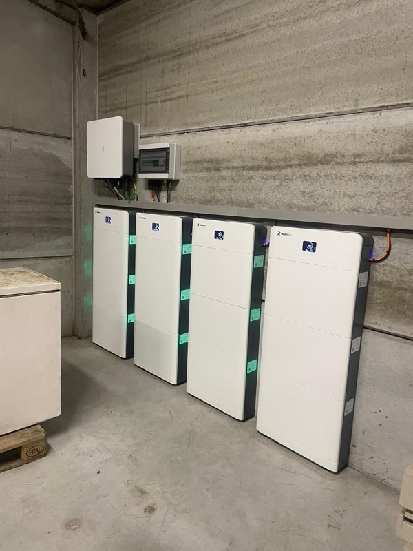 Four wall-mounted battery modules and an inverter in a basement, connected over 4G by FlatTurtle