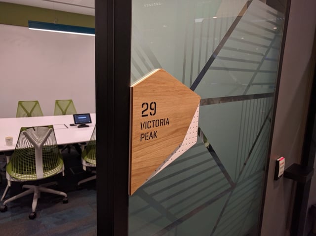 Meeting room door with a Victoria Peak name plate and a booking screen inside